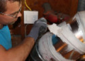 crew sealing ducts with mastic