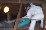 a crew member blowing in attic insulation