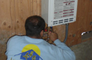 putting the finishing touches on a tankless water heater install