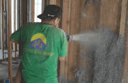 wet spray cellulose being installed in open walls