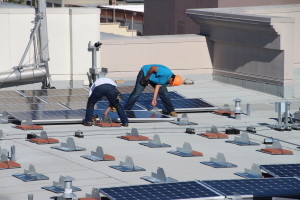 installing the solar panels on the roof of the Broadway Grand building in Oakland, CA